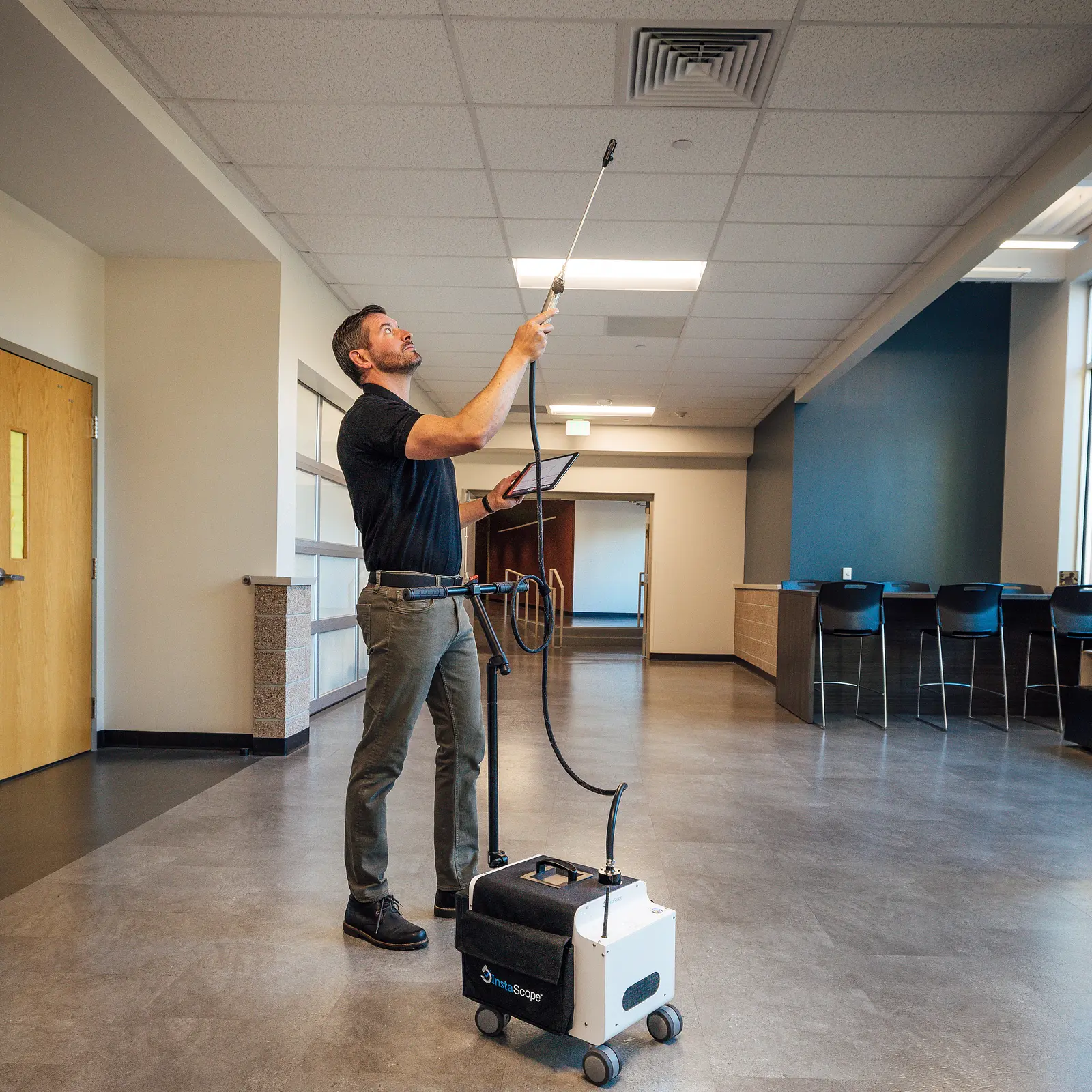 Pure Air Alabama technician scanning a ceiling vent with the InstaScope wand